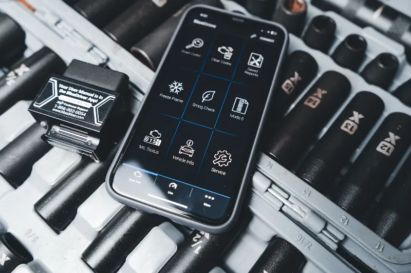 OBD adapter and diagnostics app on a phone